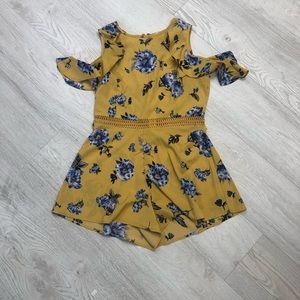 A floral romper with ruffle sleeves and a space